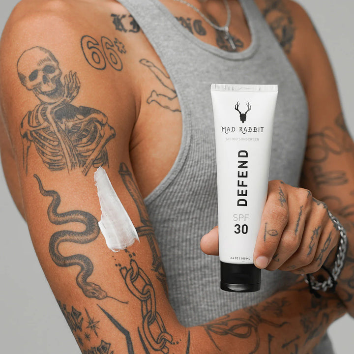 sunscreen on an arm to protect tattoos from sun damage
