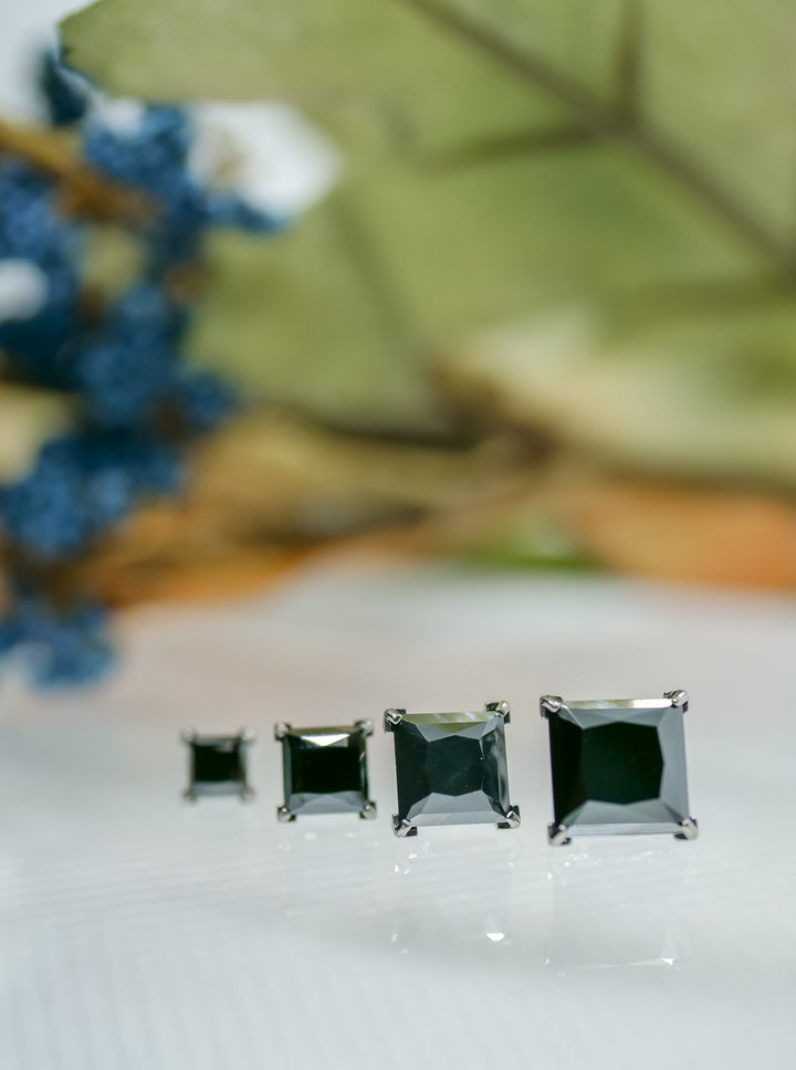 various sizes of princess cut stones in black