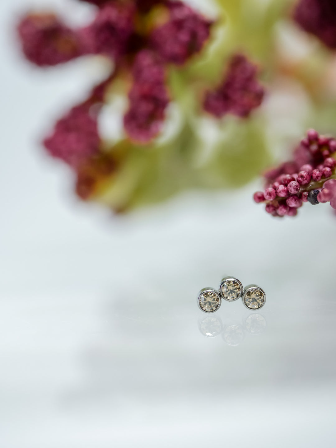 three 1.5mm wheat coloured cluster bezel set body piercing jewelry