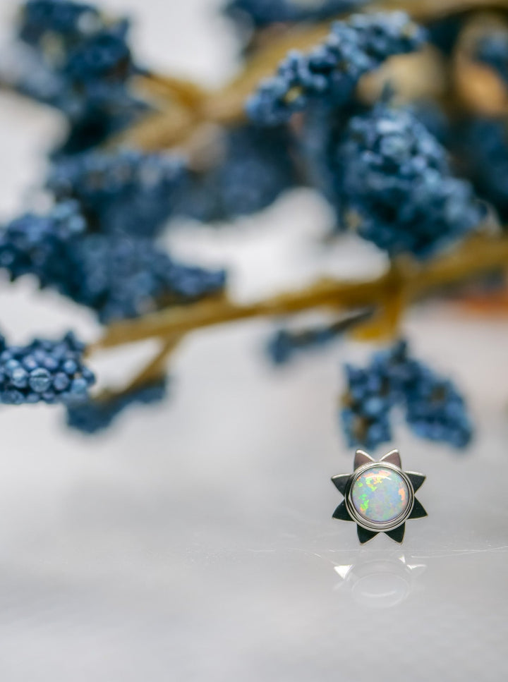 white opal cabochon 3mm in titanium sun burst setting