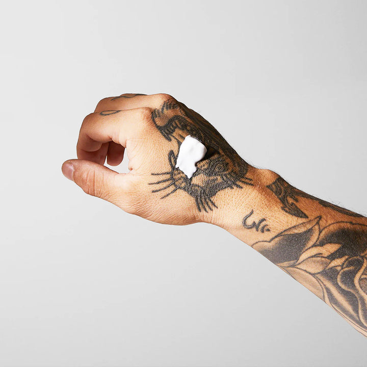 mad rabbit numbing cream on tattooed hand 
