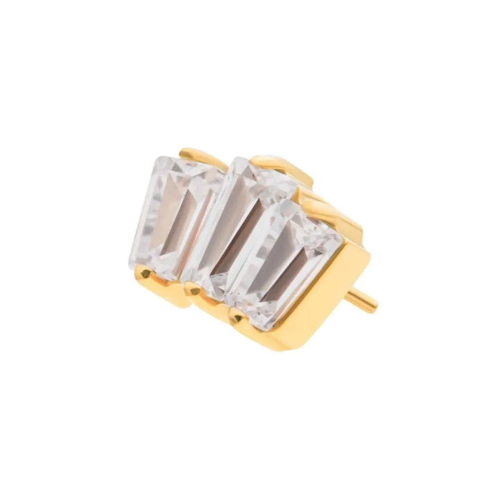 Gold PIERCING JEWELRY with three clear gemstones on a white background