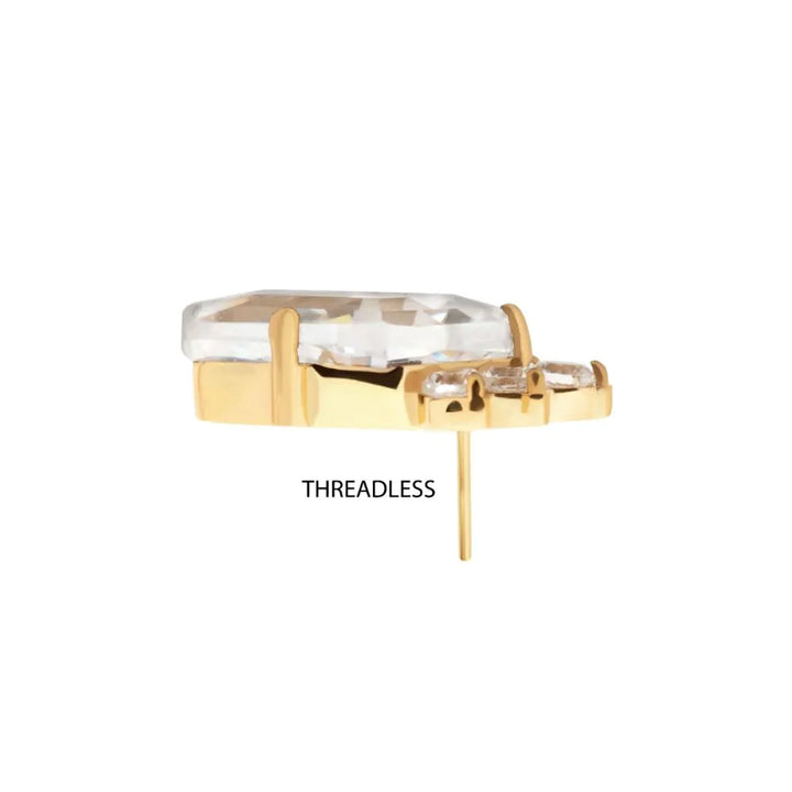 Gold body kite shaped jewelry with clear gemstone on a white background