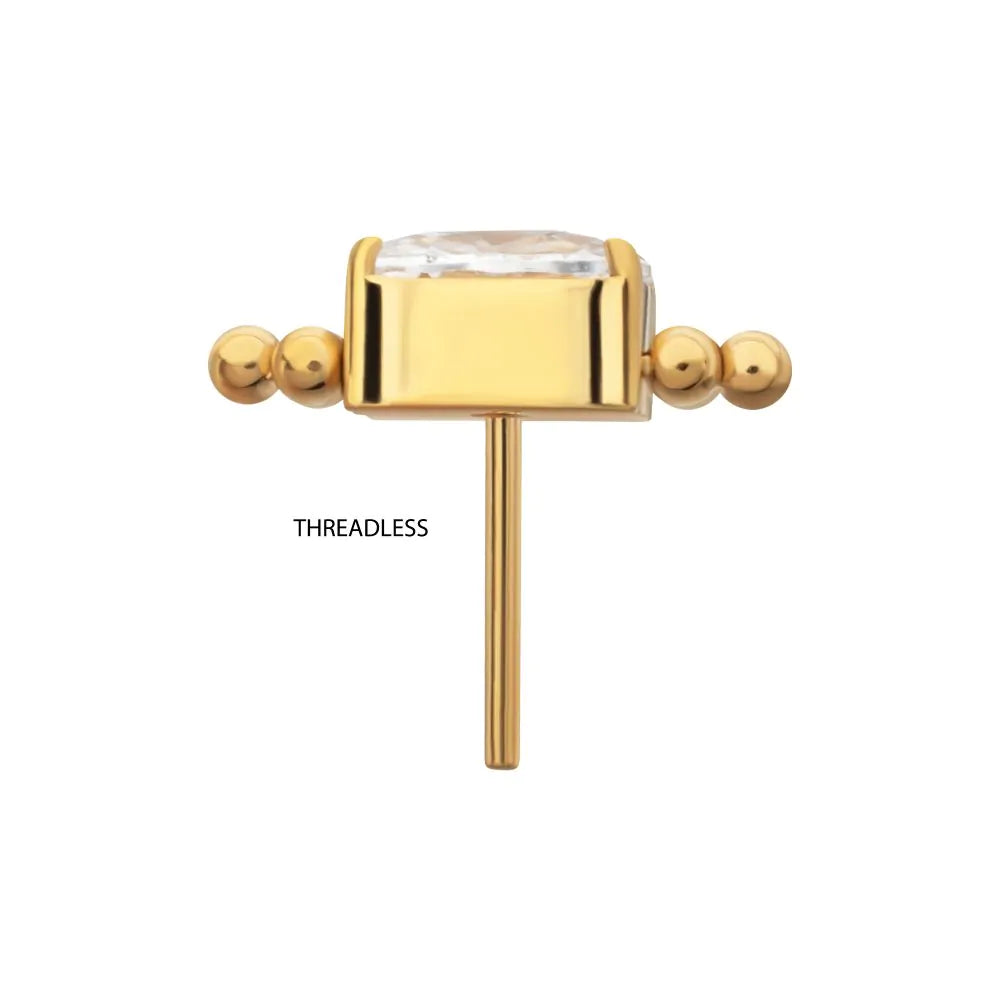 Gold threadless end with a clear gemstone on a white background