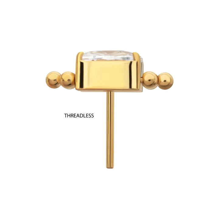 Gold threadless end with a clear gemstone on a white background