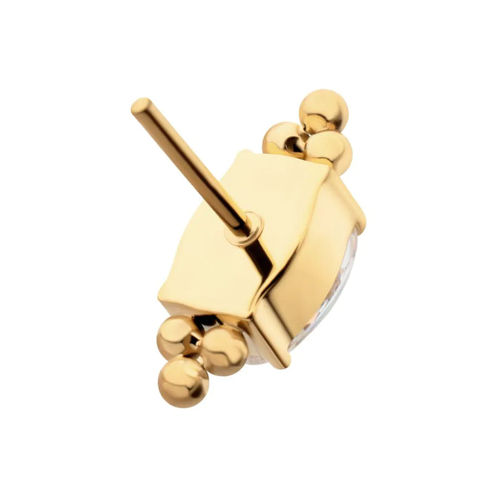 Gold earring with a unique design on a white background