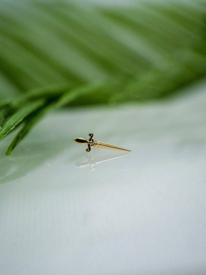 yellow gold dagger style piercing