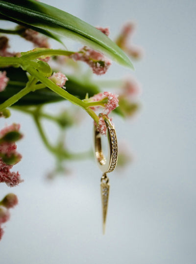 dangling spike on gold hoop studded with cubic zirconia