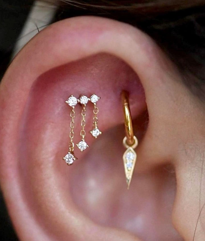 dangling charms and chains in flat cartilage piercing