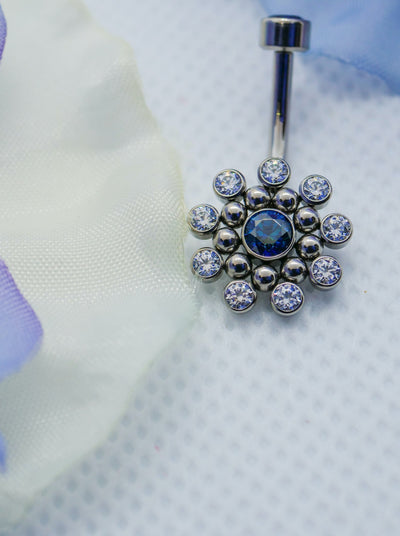 flower star burst navel curved belly button ring with blue gems