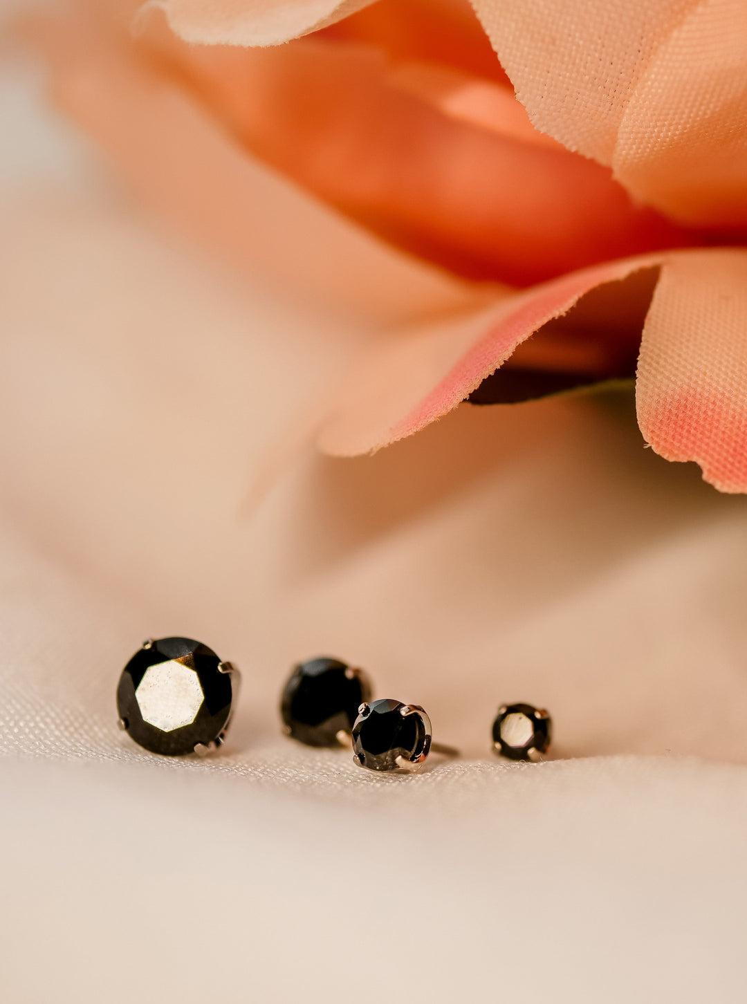 assorted sized black swarovski stones in prong settings