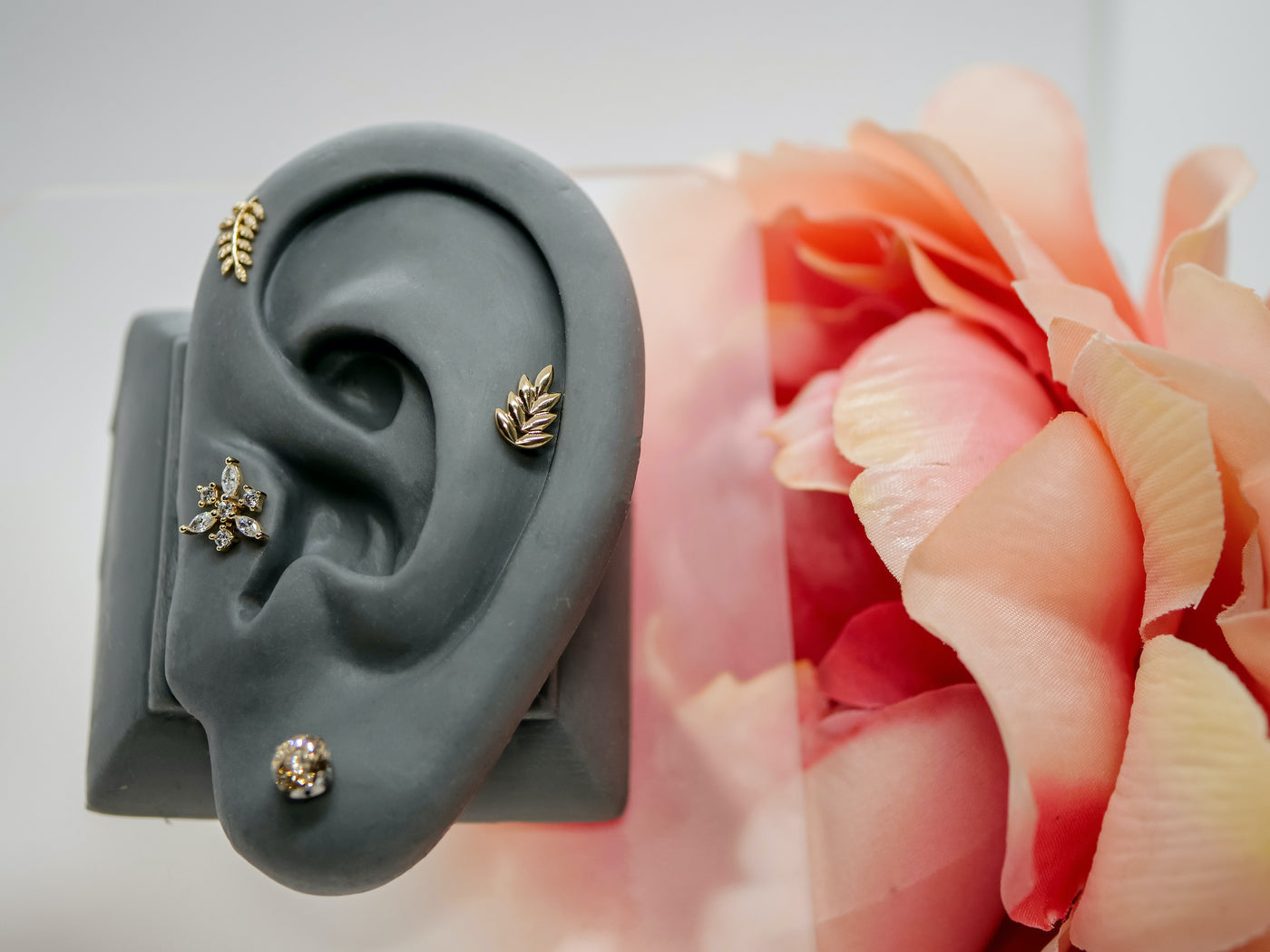 cartilage yellow gold threadless end and tragus snowflake with willow branch and champagne prong set in lobe 
