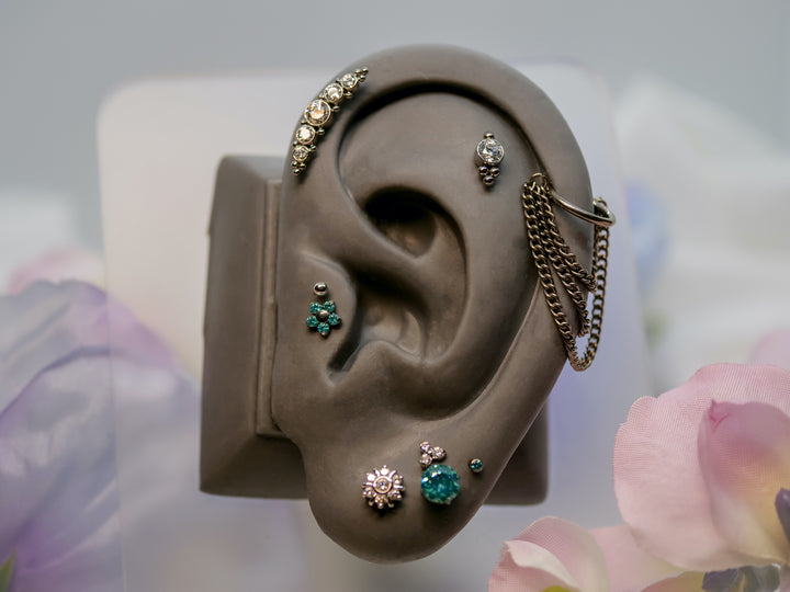 her majesty forward helix, charles threadless end, and chain ends, flower mint green by neometal and white gold ball from junipurr, prong set mint green 